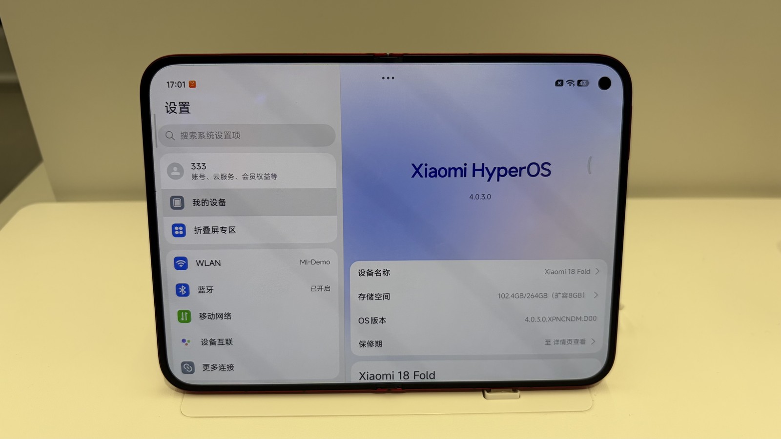 Xiaomi 18 Fold opened on a display stand, showing its system settings