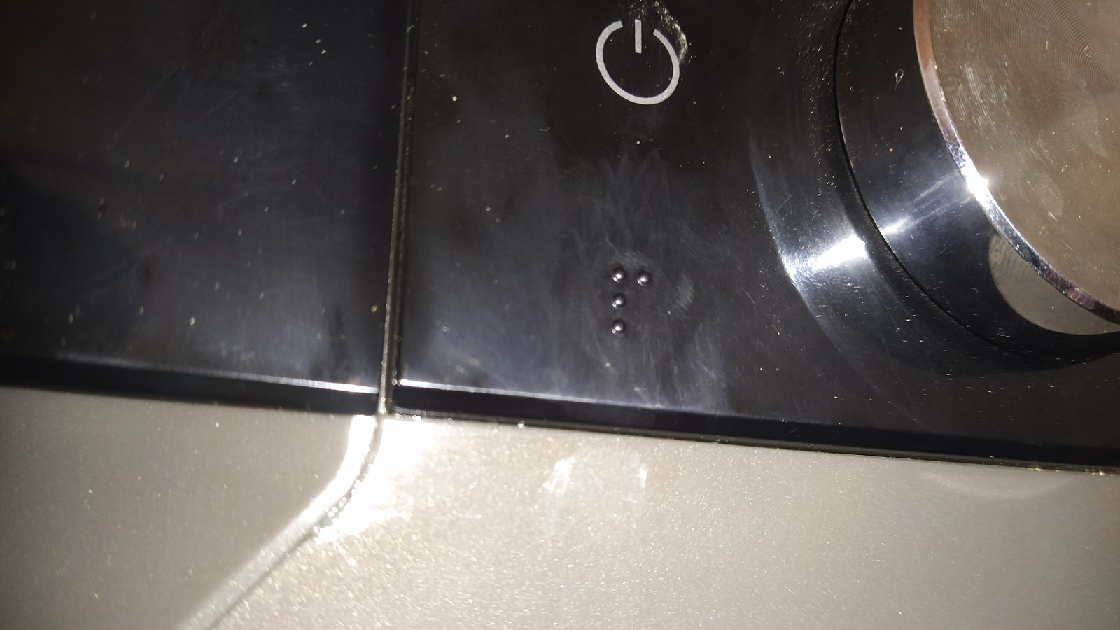 Braille dots below the power control of a Samsung washing machine